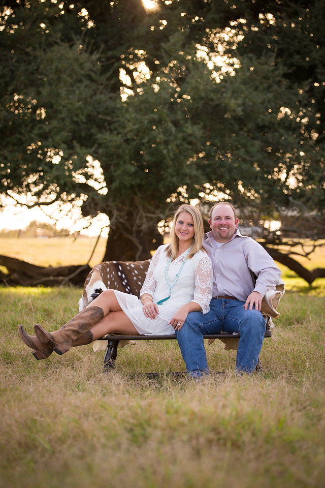 bride and groom in field at san antonio engagement session