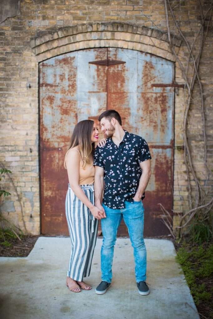 Liz and Ruben engagement rusted wall downtown New Braunfels