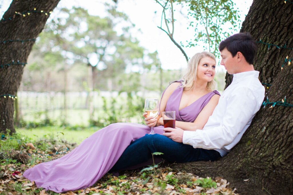 Michele Engagement session at Oak Valley Vineyards sitting in trees drinking wine