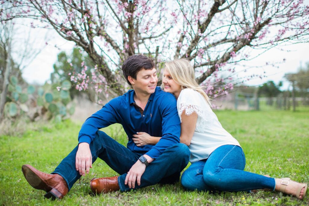 Michele Engagement session at Oak Valley Vineyards sitting by the pink tree.