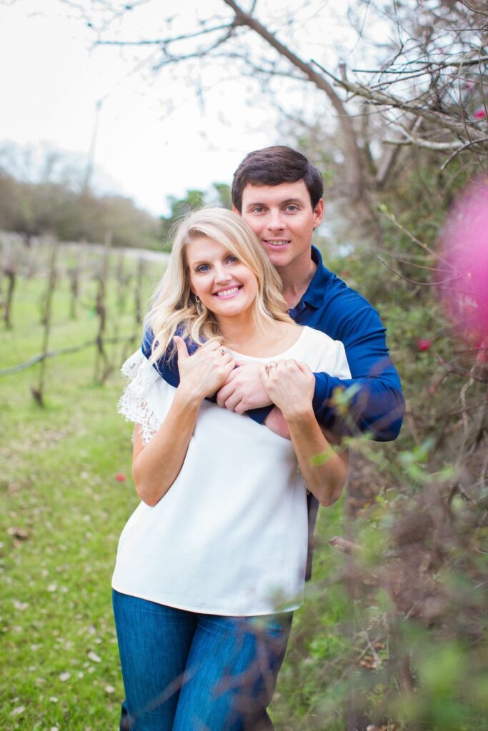 Michele Engagement session at Oak Valley Vineyards in the roses holding each other.