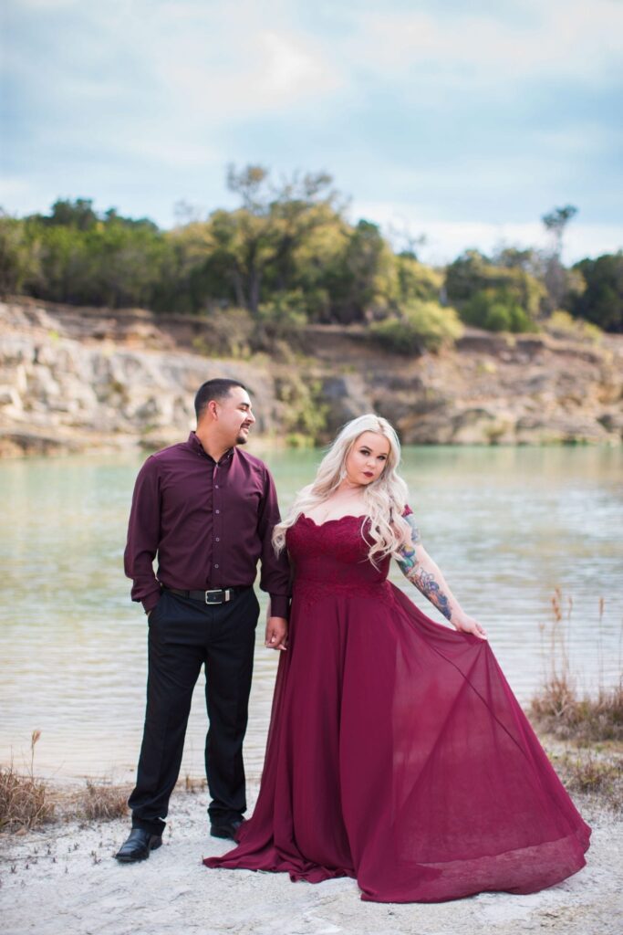 Katie and Gabe engagement session Canyon Lake dam gorge on the island looking at dress