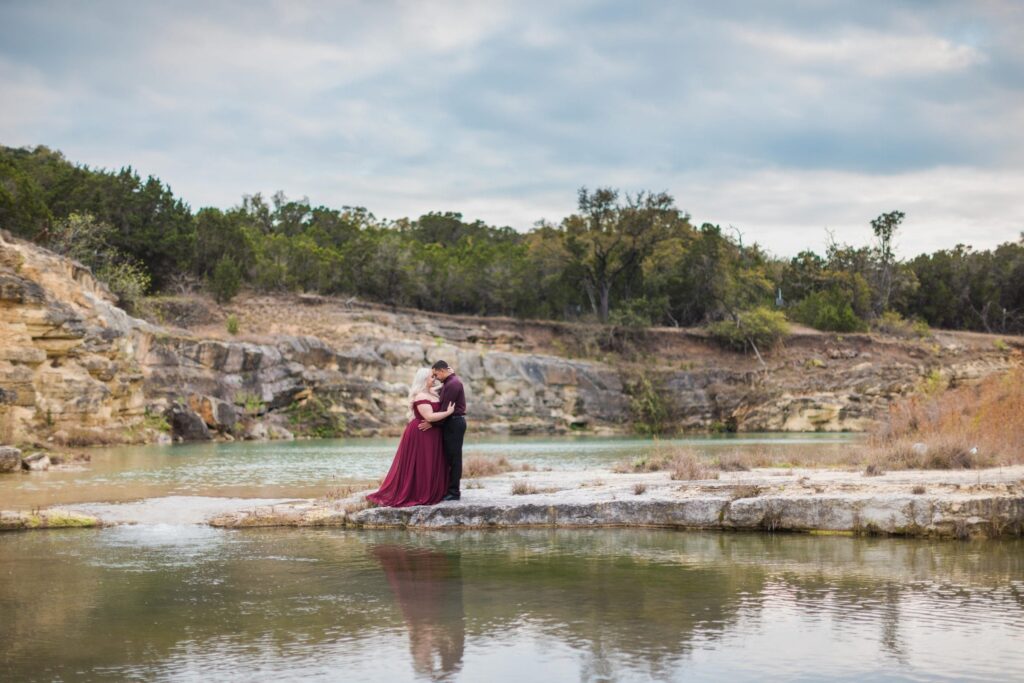 Katie and Gabe engagement session Canyon Lake dam gorge on the island looking at ea other at water fall
