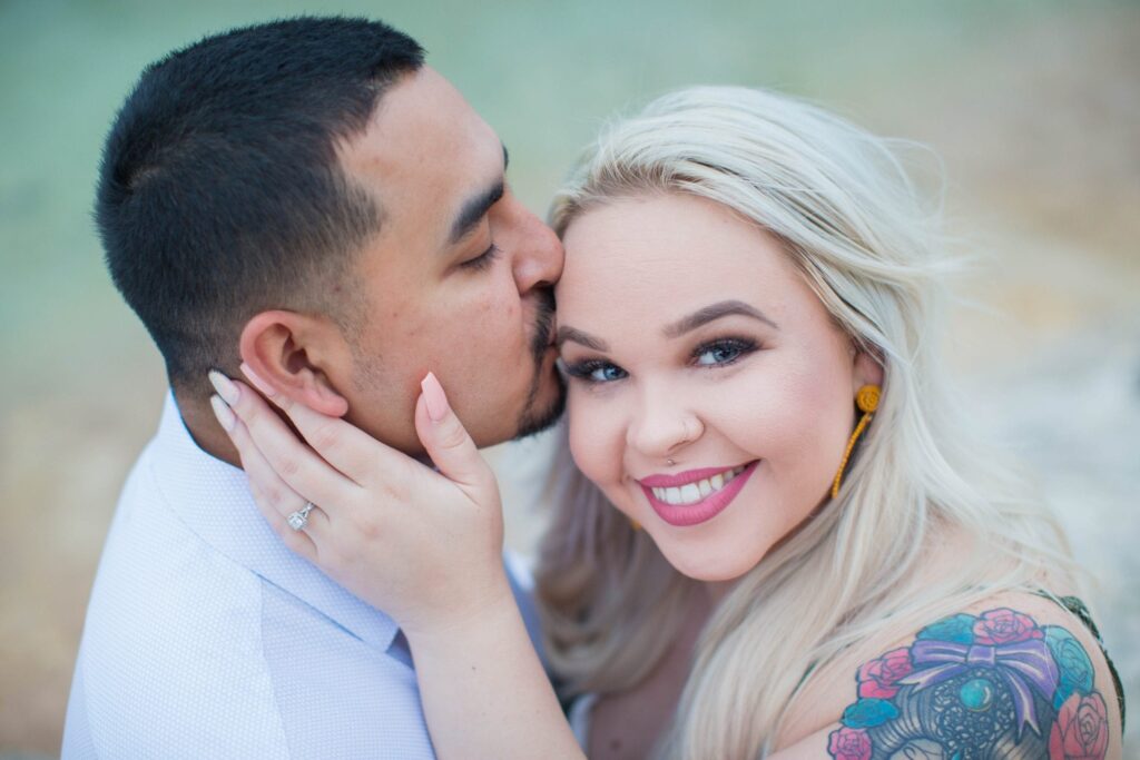 Katie & Gabe engagement session Canyon Lake dam on the water close up Katie looking Gabe kissing