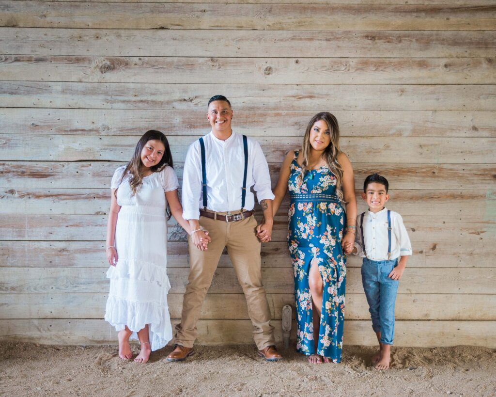 Ashley and Andy's engagement session Gruene wooden wall family