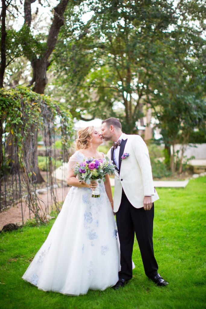 Lisa and Michael Wedding at the Veranda kiss at arch