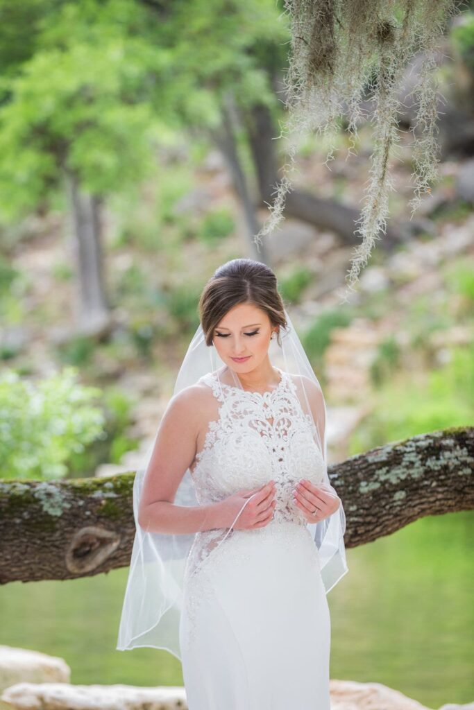 Samantha's Bridal Hidden Falls back of gown under the tree close up pensive