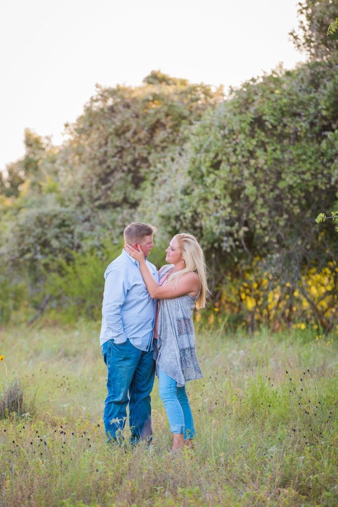 Whitney and Craig's ranch Engagement session tall grass looking