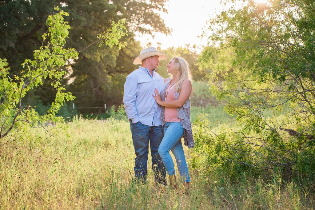 Whitney and Craig's ranch Engagement session back lit
