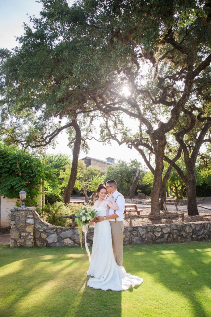 Aamber wedding Canyon Springs Golf Course couple by stone wall with sun
