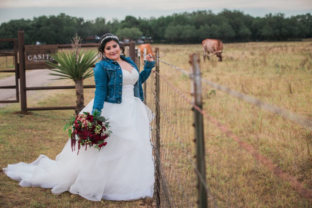 Laura's Bridals at Western Sky in the field at the gate with cow