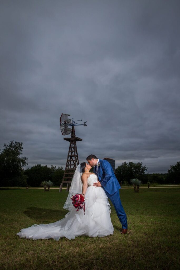 Laura wedding Western Sky couple kiss windmill