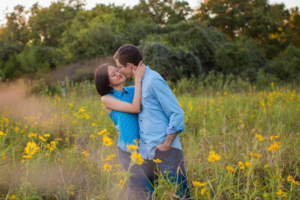 Josh and Tina engagement session at park in tall grass with flowers