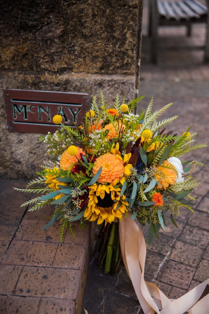 Fall styled shoot at the McNay art museum flowers by the sign