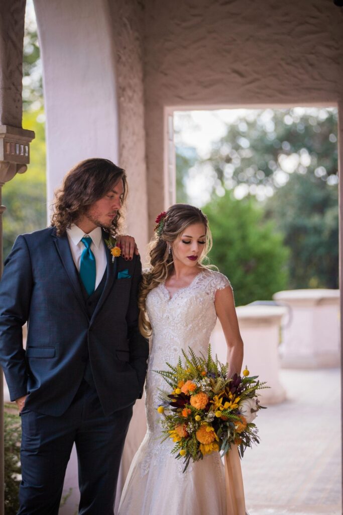 Fall styled shoot at the McNay art museum couple in arches looking down bride