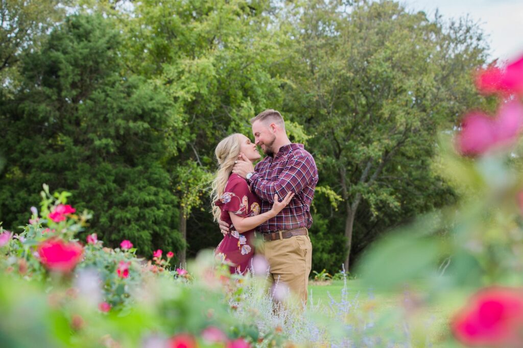 molly engagement Texas a and M behind the flowers hugging