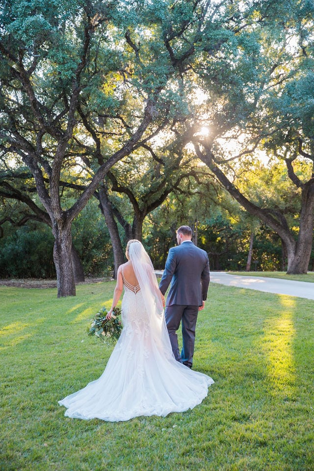 Molly and Michael at the Chandelier of Gruene couple walking on grass