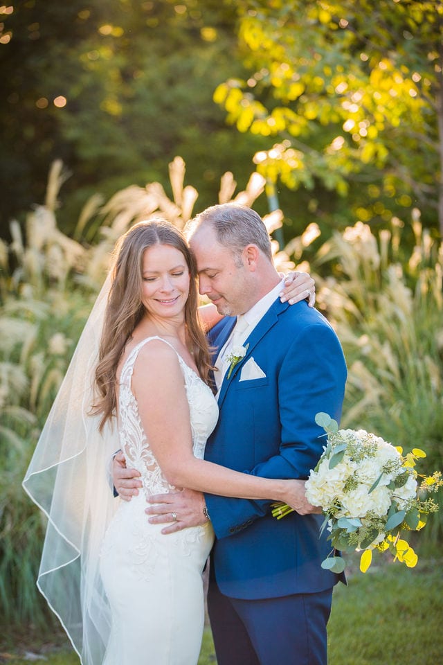 David and Angie wedding at The Kendall Inn bride and groom by pampas grass moment