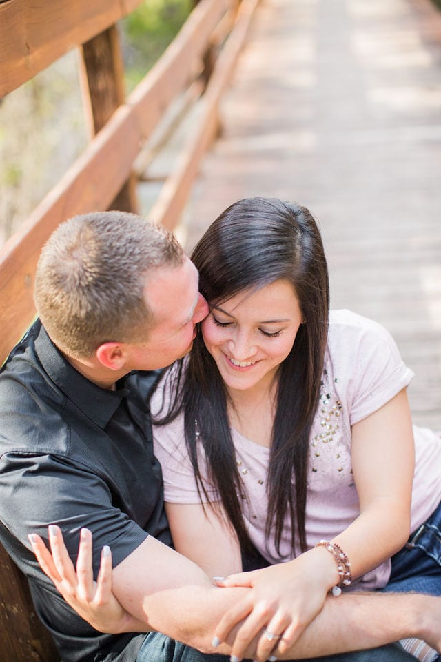 Stefan and Ashley's engagement session. Sitting on the bridge