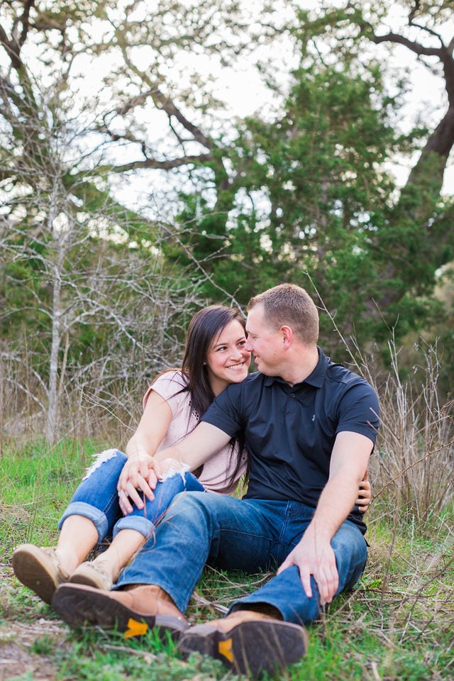 Stefan and Ashley's engagement session. Couple in the trees sitting