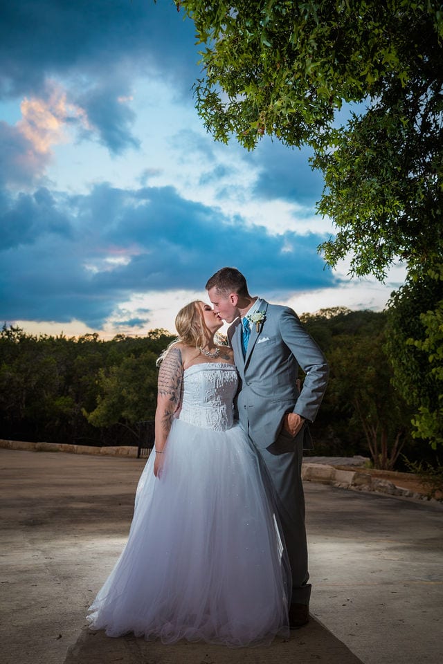 Kristina and Brandon's Wedding kiss in the sunset Kendall Plantation
