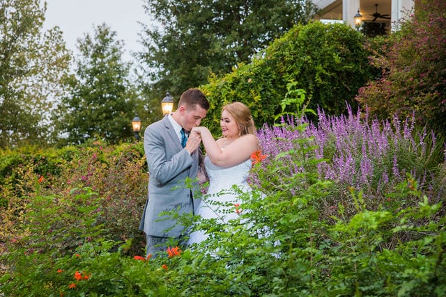 Kristina and Brandon's Wedding kiss in the purple flowers Kendall Plantation