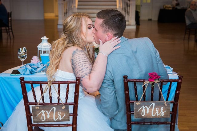 Kristina and Brandon's Wedding at Kendall plantation kiss at head table