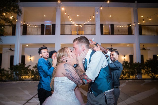 Kristina and Brandon's Wedding at Kendall plantation exit kiss