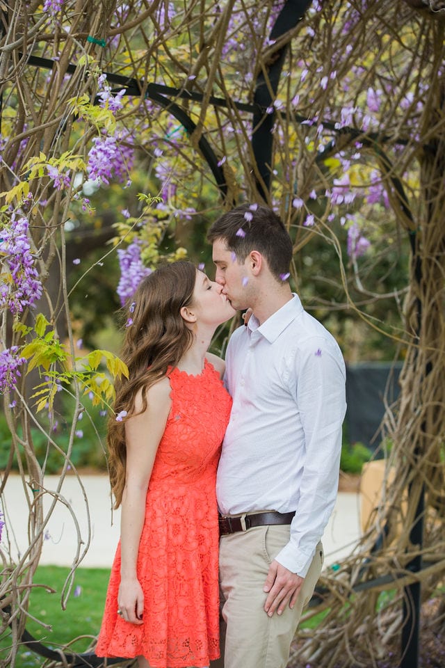 Claire & Josh engagement session San Antonio Botanical Gardens wisteria falling