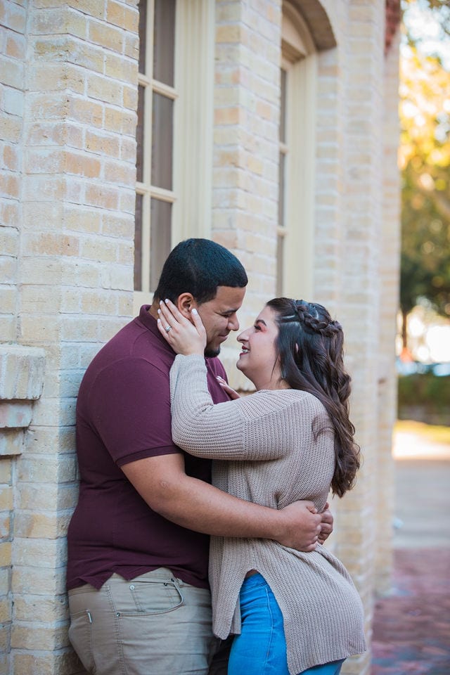 Dana and Andrews engagement session at the Pearl Stable wall