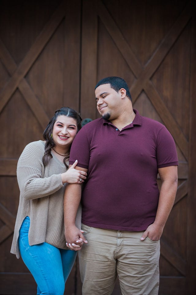 Dana and Andrews engagement session at the Pearl Stable doors laughing