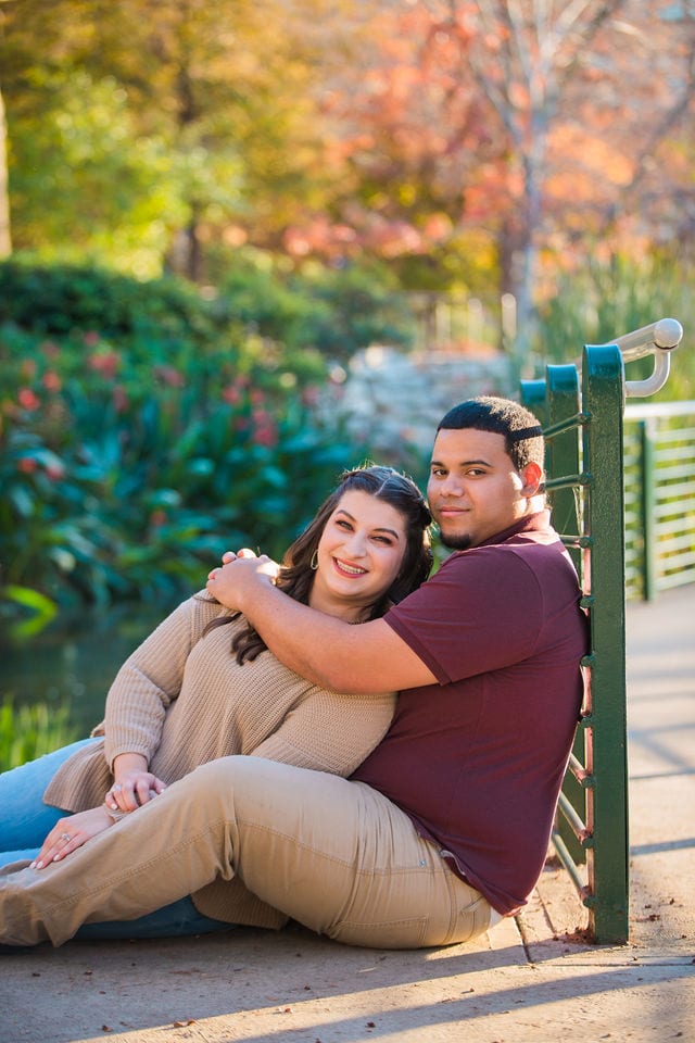 Dana and Andrews engagement session at the Pearl seated on the river bridge