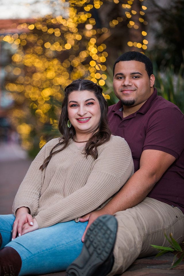 Dana and Andrews engagement session at the Pearl with Christmas lights seated
