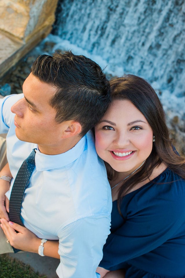 Anthony Engagement session at La Cantera Resort waterfall behind her looking up