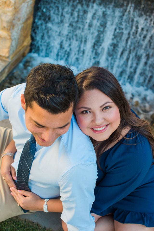 Anthony Engagement session at La Cantera Resort waterfall behind her looking up laughing