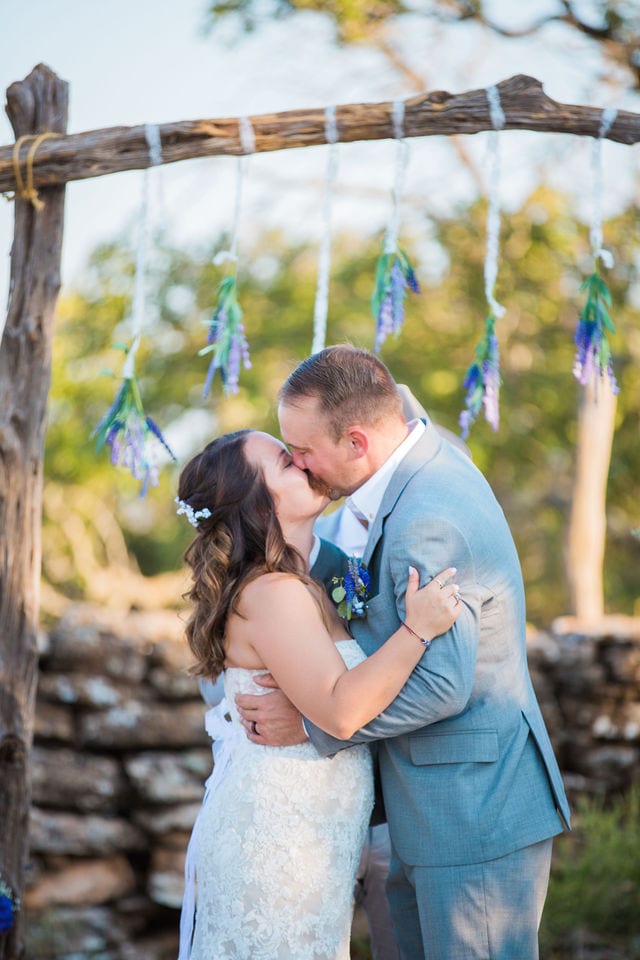 Keely's wedding in Mason TX, ceremony kiss