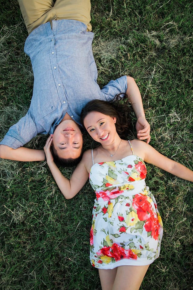 Sarah and Ming's Engagement Laying in the grass