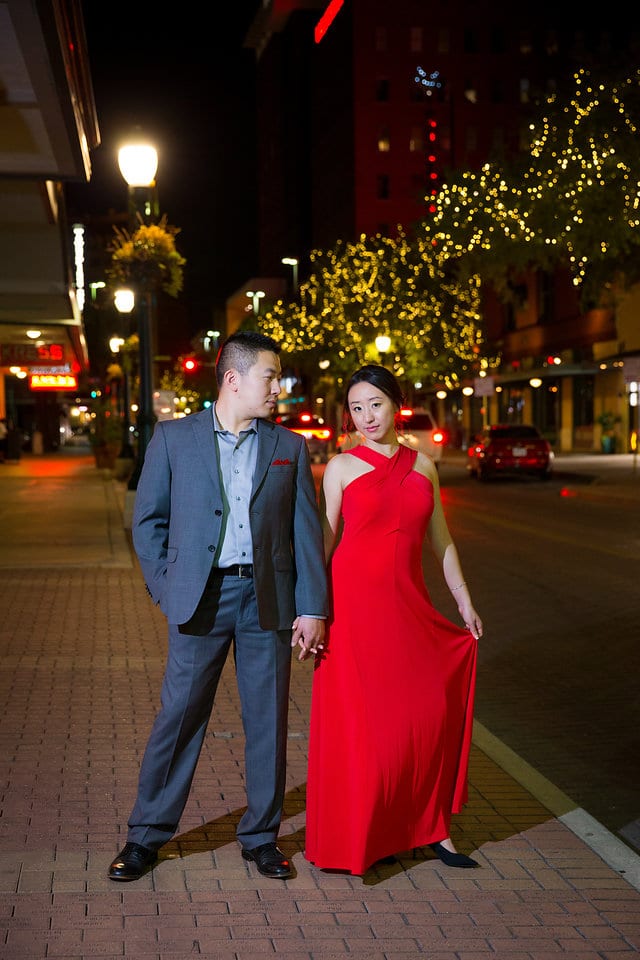 Sarah and Ming's Engagement downtown holding hands