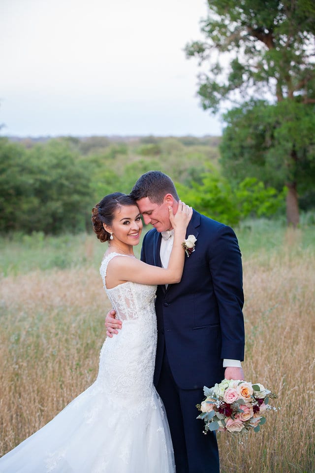 Amberlynn's wedding at The Milestone New Braunfels couple portrait in the grass