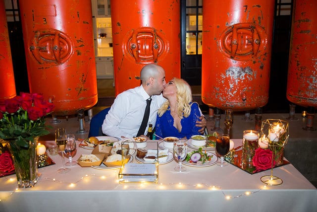 Chantel wedding at Hotel Emma reception couple kissing at the table