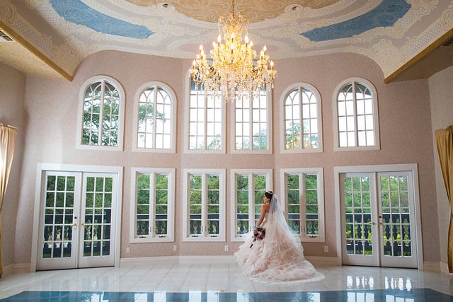 Emilia's Bridal in the ballroom at Castle Avalon at bank of windows