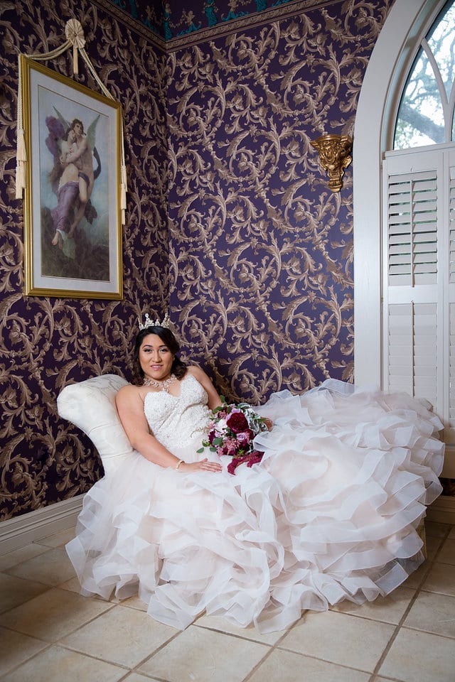 Emilia's Bridal in the ballroom at Castle Avalon bridal suite on the sofa
