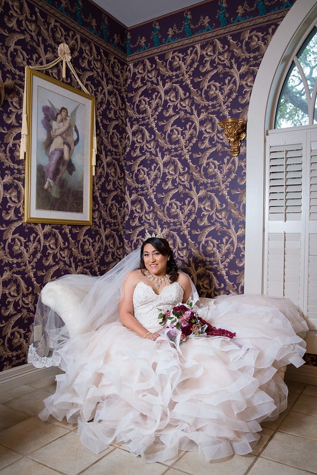 Emilia's Bridal in the ballroom at Castle Avalon bridal suite on the sofa giggling