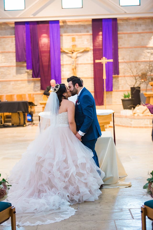Emilia's wedding at St Francis de Assisi in San Antonio ceremony kiss
