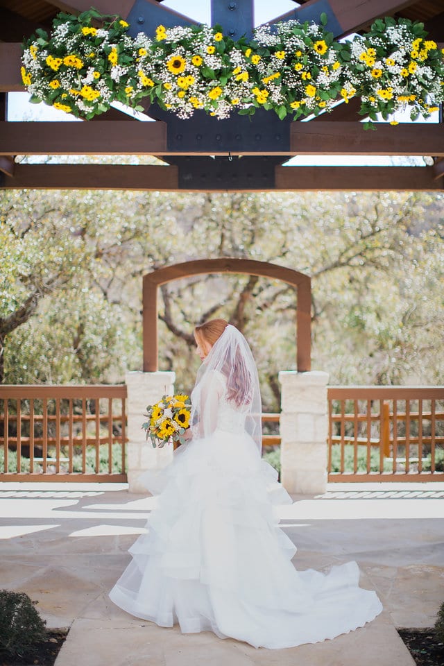 Jamie's Bridal at the Milestone in Boerne back of the dress at the gazebo with flowers