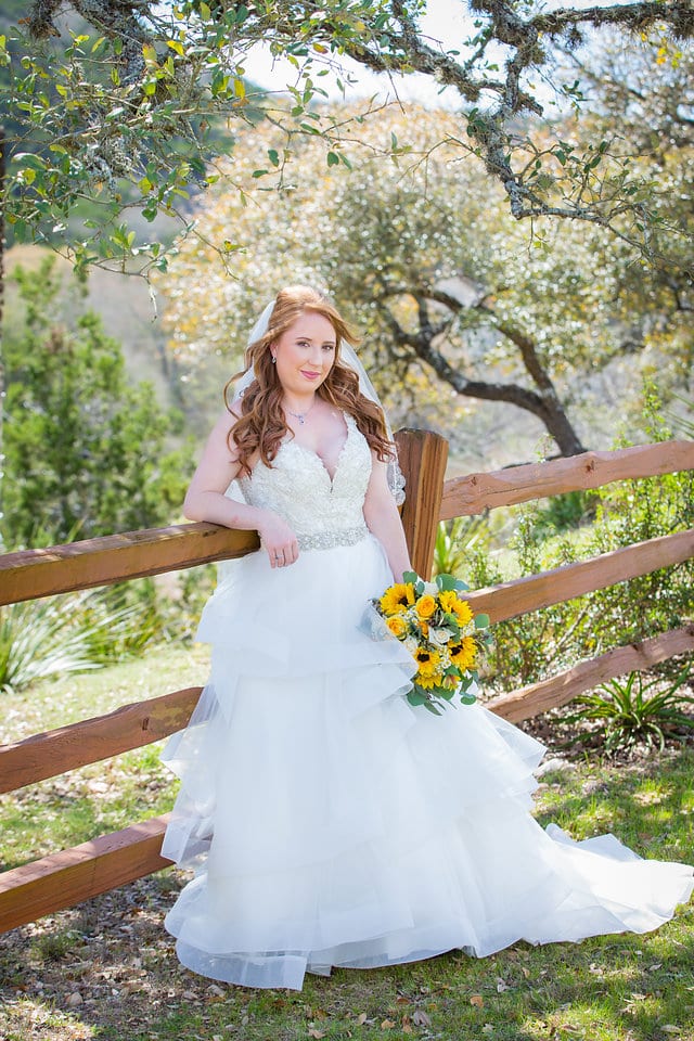 Jamie's Bridal at the Milestone in Boerne portrait by the fence flowers down