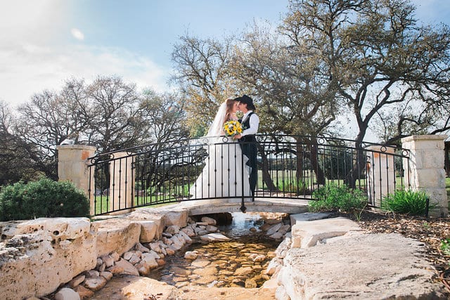 Jamie's wedding at the Milestone in Boerne the couple on the bridge kissing