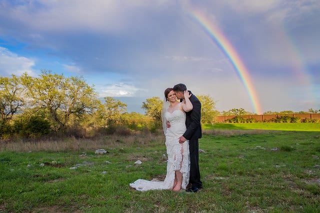 Katie Z wedding at tThe Milestone New Braunfels the bride and groom with rainbow snuggle