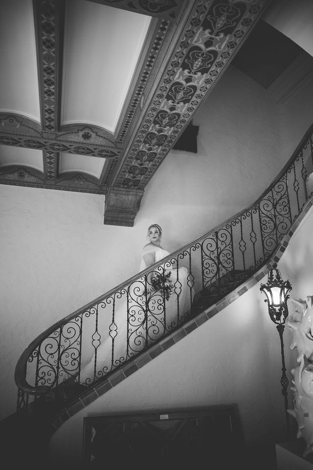Katie's Bridal session at the McNay posed at the top of the staircase black and white.