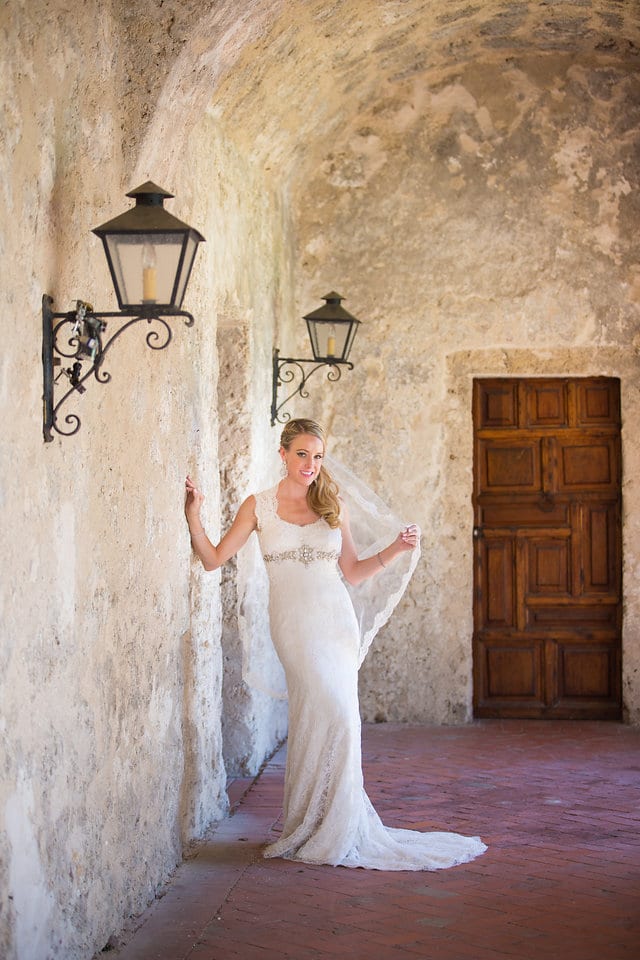 Kimb bridal at Mission Conception lamps on wall portrait